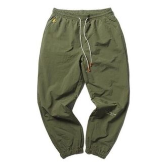 Spodnie tkane PUMA x Randomevent w kolorze zielonym